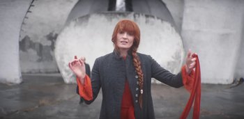 Movie still from “Florence + The Machine - Free” (2022), directed by Autumn de Wilde – Medium shot, Low angle
