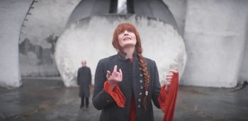 Movie still from “Florence + The Machine - Free” (2022), directed by Autumn de Wilde – Medium shot, Low angle