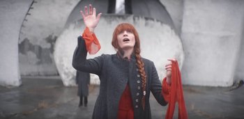 Movie still from “Florence + The Machine - Free” (2022), directed by Autumn de Wilde – Medium shot, Low angle