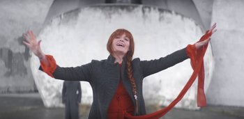Movie still from “Florence + The Machine - Free” (2022), directed by Autumn de Wilde – Medium shot, Low angle
