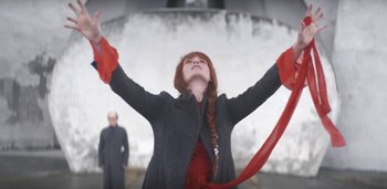 Movie still from “Florence + The Machine - Free” (2022), directed by Autumn de Wilde – Medium shot, Low angle