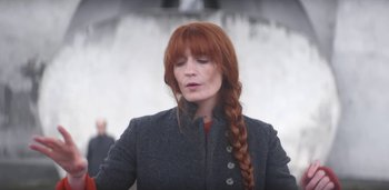 Movie still from “Florence + The Machine - Free” (2022), directed by Autumn de Wilde – Medium shot, Low angle