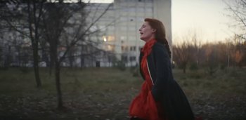 Movie still from “Florence + The Machine - Free” (2022), directed by Autumn de Wilde – Medium shot, Low angle