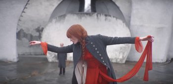 Movie still from “Florence + The Machine - Free” (2022), directed by Autumn de Wilde – Medium shot, Low angle