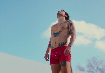 Movie still from “Harry Styles - As It Was” (2022), directed by Tanu Muiño – Medium shot, Low angle