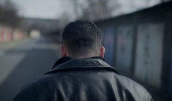 Movie still from “Anima Sound System - Dress Me In White” (2022), directed by Luka Kostil – Close Up shot, Over the shoulder angle