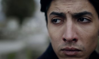 Movie still from “Anima Sound System - Dress Me In White” (2022), directed by Luka Kostil – Extreme Close Up shot, Low angle