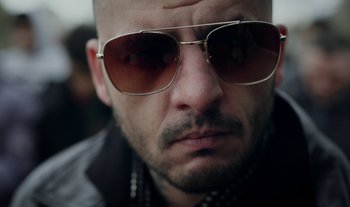 Movie still from “Anima Sound System - Dress Me In White” (2022), directed by Luka Kostil – Close Up shot, Low angle