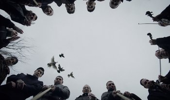 Movie still from “Anima Sound System - Dress Me In White” (2022), directed by Luka Kostil – Extreme Close Up shot, Overhead angle