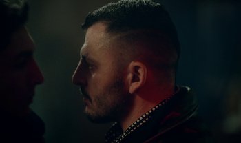 Movie still from “Anima Sound System - Dress Me In White” (2022), directed by Luka Kostil – Close Up shot, Low angle