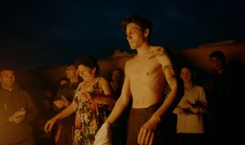 Movie still from “Anima Sound System - Dress Me In White” (2022), directed by Luka Kostil – Medium shot, Low angle