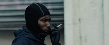 Movie still from “Chase & Status - When It Rains” (2022), directed by Hector Dockrill – Close Up shot, Low angle