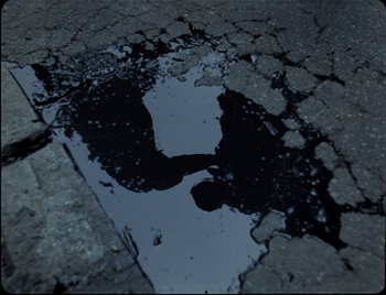Movie still from “Ziak - Akimbo” (2021), directed by Bleu Désert – Extreme Close Up shot, Overhead angle