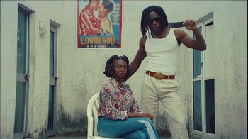 Movie still from “Little Simz ft. Obongjayar - Point And Kill” (2021), directed by Ebeneza Blanche – Medium shot, Low angle