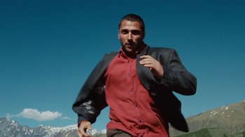 Movie still from “BadBadNotGood - Beside April” (2021), directed by Camille Summers-Valli – Medium shot, Low angle