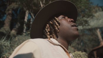 Movie still from “Masego - Mystery Lady” (2021), directed by Douglas Bernardt – Close Up shot, Low angle