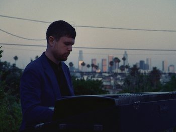 Movie still from “James Blake - Say What You Will” (2021), directed by Bear Damen – Medium shot, Low angle