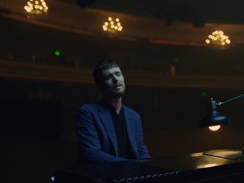 Movie still from “James Blake - Say What You Will” (2021), directed by Bear Damen – Medium shot, Low angle