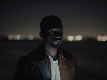 Movie still from “Sam Dew - NTWFL” (2020), directed by Young Replicant – Close Up shot, Low angle