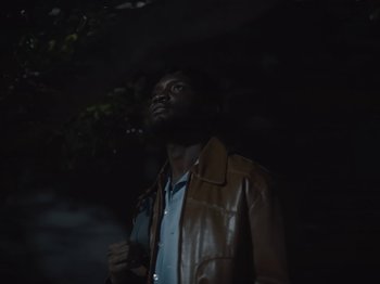 Movie still from “Sam Dew - NTWFL” (2020), directed by Young Replicant – Medium shot, Low angle