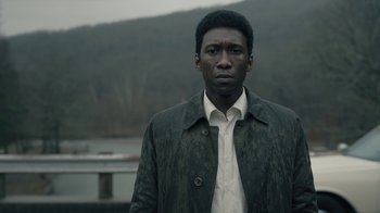 Movie still from “True Detective” (2014), created by Issa López – A man standing in front of a body of water; Close Up shot, Over the shoulder angle