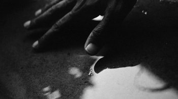 Movie still from “Jurdan Bryant - Words for Thomas” (2019), directed by Alonzo Hellerbach – Extreme Close Up shot, High angle