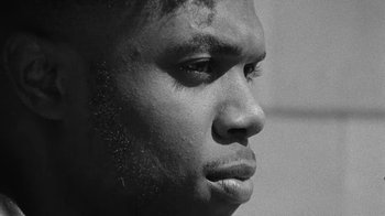 Movie still from “Jurdan Bryant - Words for Thomas” (2019), directed by Alonzo Hellerbach – Close Up shot, Low angle