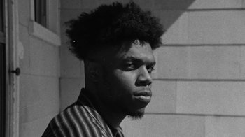 Movie still from “Jurdan Bryant - Words for Thomas” (2019), directed by Alonzo Hellerbach – Close Up shot, Low angle