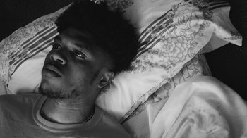 Movie still from “Jurdan Bryant - Words for Thomas” (2019), directed by Alonzo Hellerbach – Close Up shot, Overhead angle