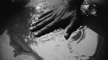 Movie still from “Jurdan Bryant - Words for Thomas” (2019), directed by Alonzo Hellerbach – Extreme Close Up shot, Overhead angle