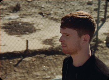 Movie still from “James Blake feat. Rosalía - Barefoot In The Park” (2019), directed by Diana Kunst – Close Up shot, High angle