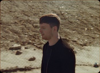 Movie still from “James Blake feat. Rosalía - Barefoot In The Park” (2019), directed by Diana Kunst – Close Up shot, Low angle