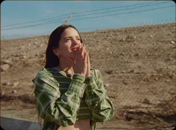 Movie still from “James Blake feat. Rosalía - Barefoot In The Park” (2019), directed by Diana Kunst – Medium shot, Low angle