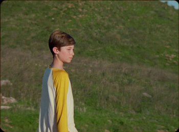 Movie still from “James Blake feat. Rosalía - Barefoot In The Park” (2019), directed by Diana Kunst – Medium shot, Low angle