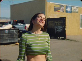 Movie still from “James Blake feat. Rosalía - Barefoot In The Park” (2019), directed by Diana Kunst – Medium shot, Low angle