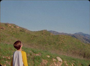 Movie still from “James Blake feat. Rosalía - Barefoot In The Park” (2019), directed by Diana Kunst – Extreme Wide shot, Low angle