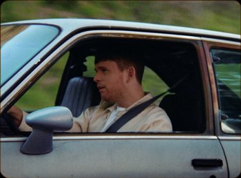 Movie still from “James Blake feat. Rosalía - Barefoot In The Park” (2019), directed by Diana Kunst – Close Up shot, Low angle