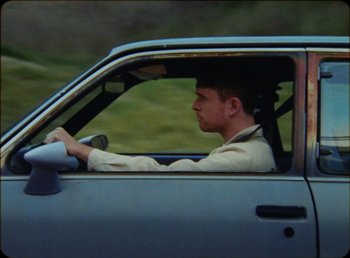 Movie still from “James Blake feat. Rosalía - Barefoot In The Park” (2019), directed by Diana Kunst – Medium shot, Low angle