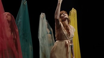 Movie still from “Florence + The Machine - Big God” (2018), directed by Autumn de Wilde – Medium shot, Low angle