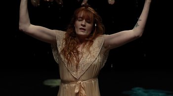 Movie still from “Florence + The Machine - Big God” (2018), directed by Autumn de Wilde – Medium shot, Low angle