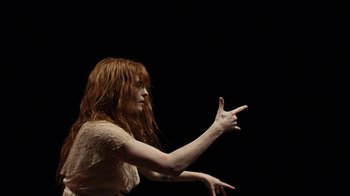 Movie still from “Florence + The Machine - Big God” (2018), directed by Autumn de Wilde – Medium shot, Overhead angle