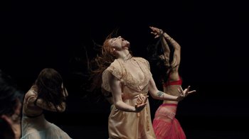 Movie still from “Florence + The Machine - Big God” (2018), directed by Autumn de Wilde – Medium shot, Low angle