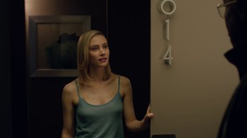 Movie still from “True Detective” (2014), created by Issa López – A beautiful young woman standing next to a building; Close Up shot, Over the shoulder angle