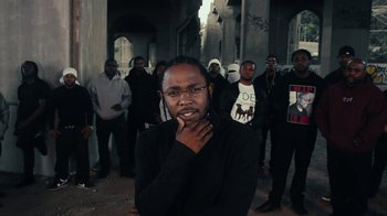Movie still from “Kendrick Lamar - HUMBLE.” (2017), directed by Dave Meyers – Medium shot, Over the shoulder angle