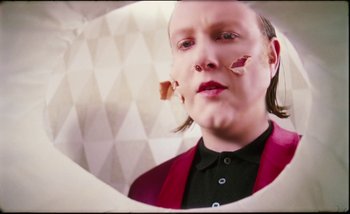 Movie still from “Two Door Cinema Club - Are We Ready” (2016), directed by Thunderlips – Close Up shot, Over the shoulder angle