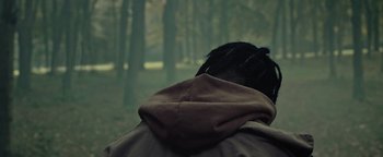 Movie still from “Travis Scott & Kanye West - Piss on your Grave” (2015), directed by Nabil Elderkin – Close Up shot, Over the shoulder angle