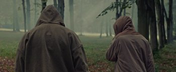 Movie still from “Travis Scott & Kanye West - Piss on your Grave” (2015), directed by Nabil Elderkin – Medium shot, Over the shoulder angle