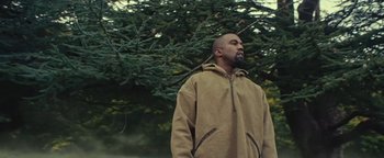 Movie still from “Travis Scott & Kanye West - Piss on your Grave” (2015), directed by Nabil Elderkin – Medium shot, Low angle