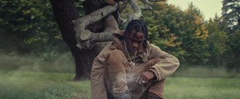 Movie still from “Travis Scott & Kanye West - Piss on your Grave” (2015), directed by Nabil Elderkin – Medium shot, Low angle