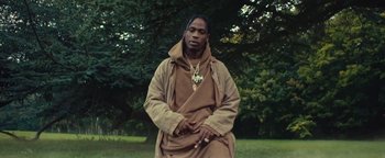 Movie still from “Travis Scott & Kanye West - Piss on your Grave” (2015), directed by Nabil Elderkin – Medium shot, Low angle